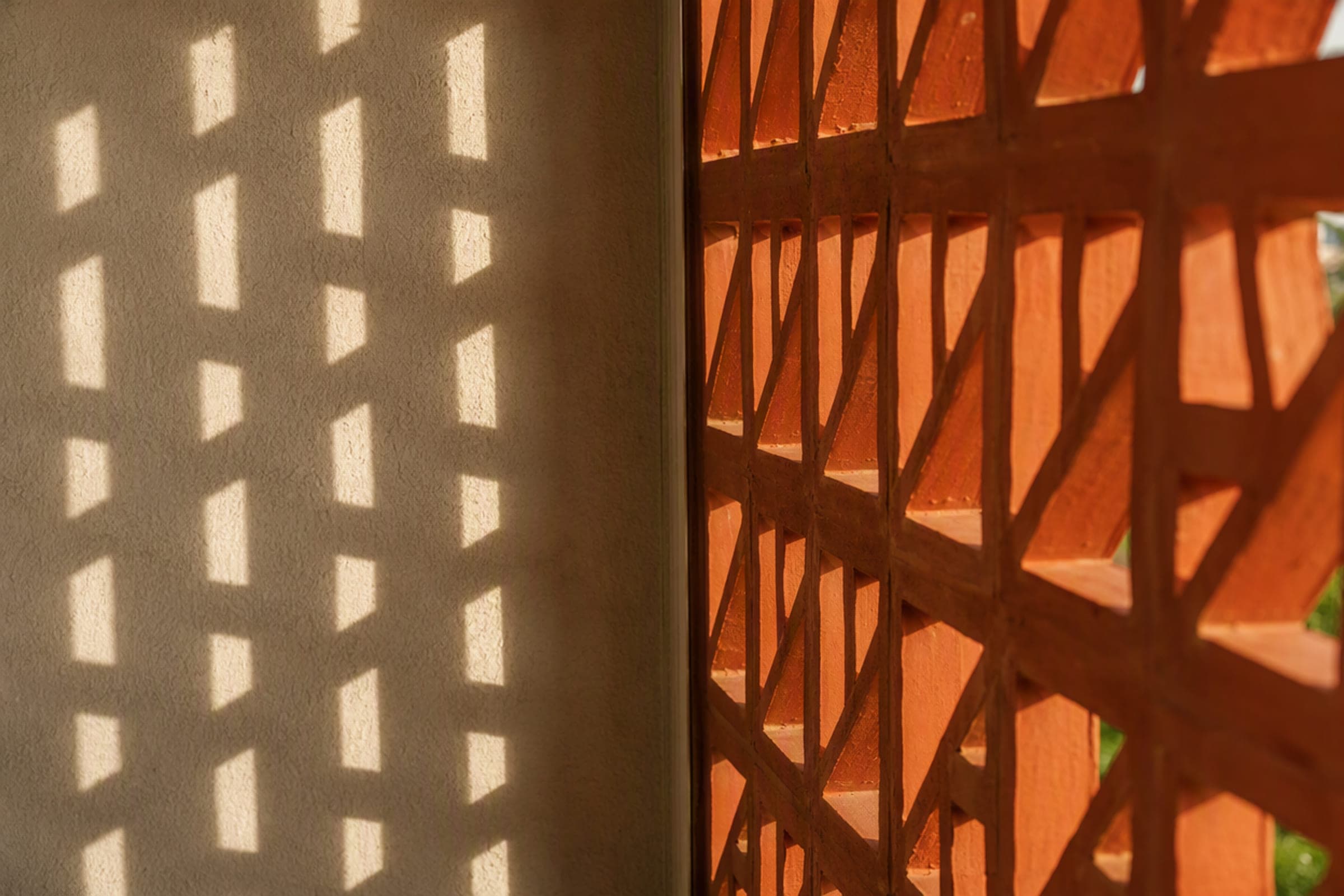 Perforated screen casting a geometric shadow